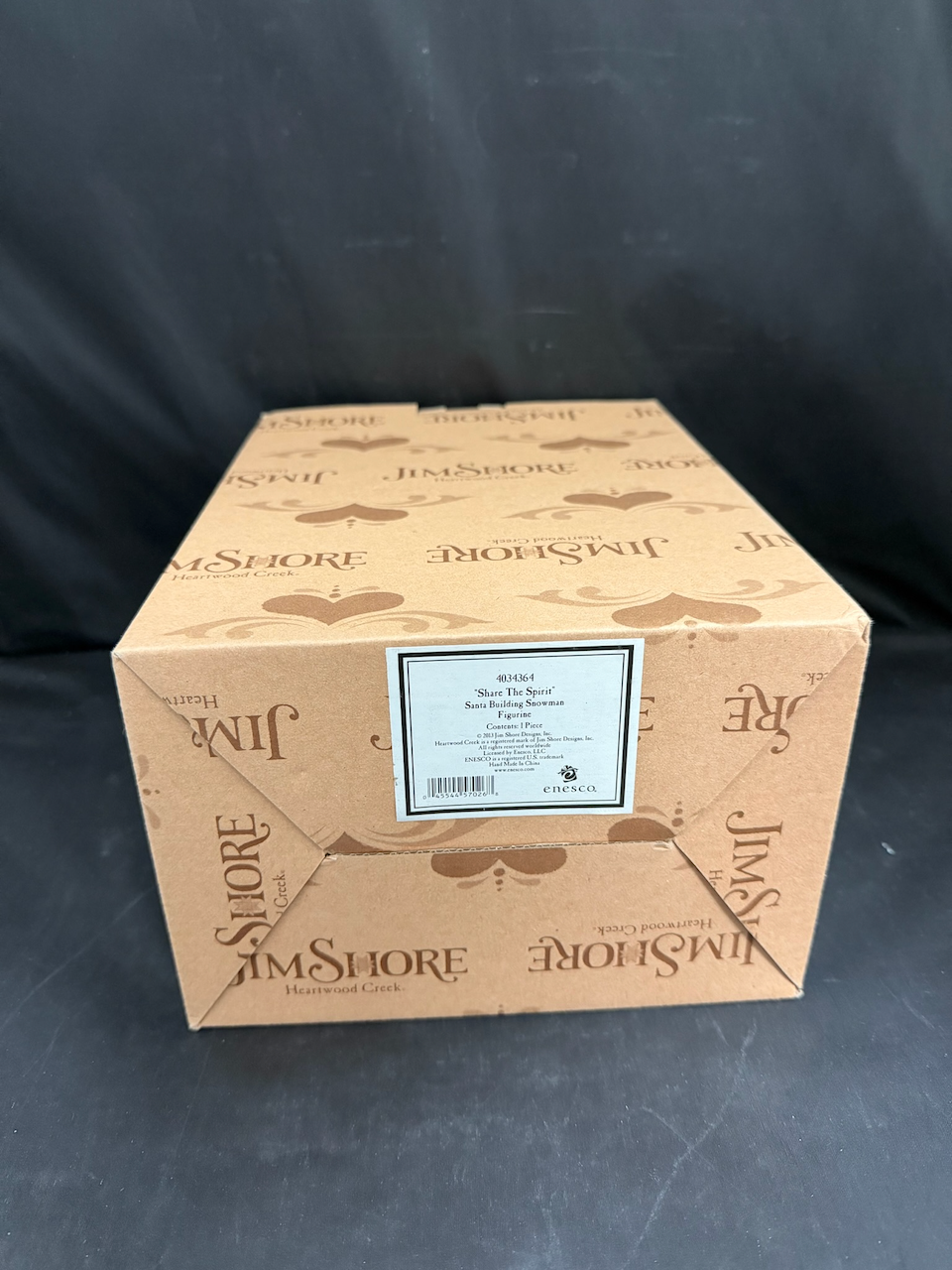 Share The Spirit. Santa Building Snowman