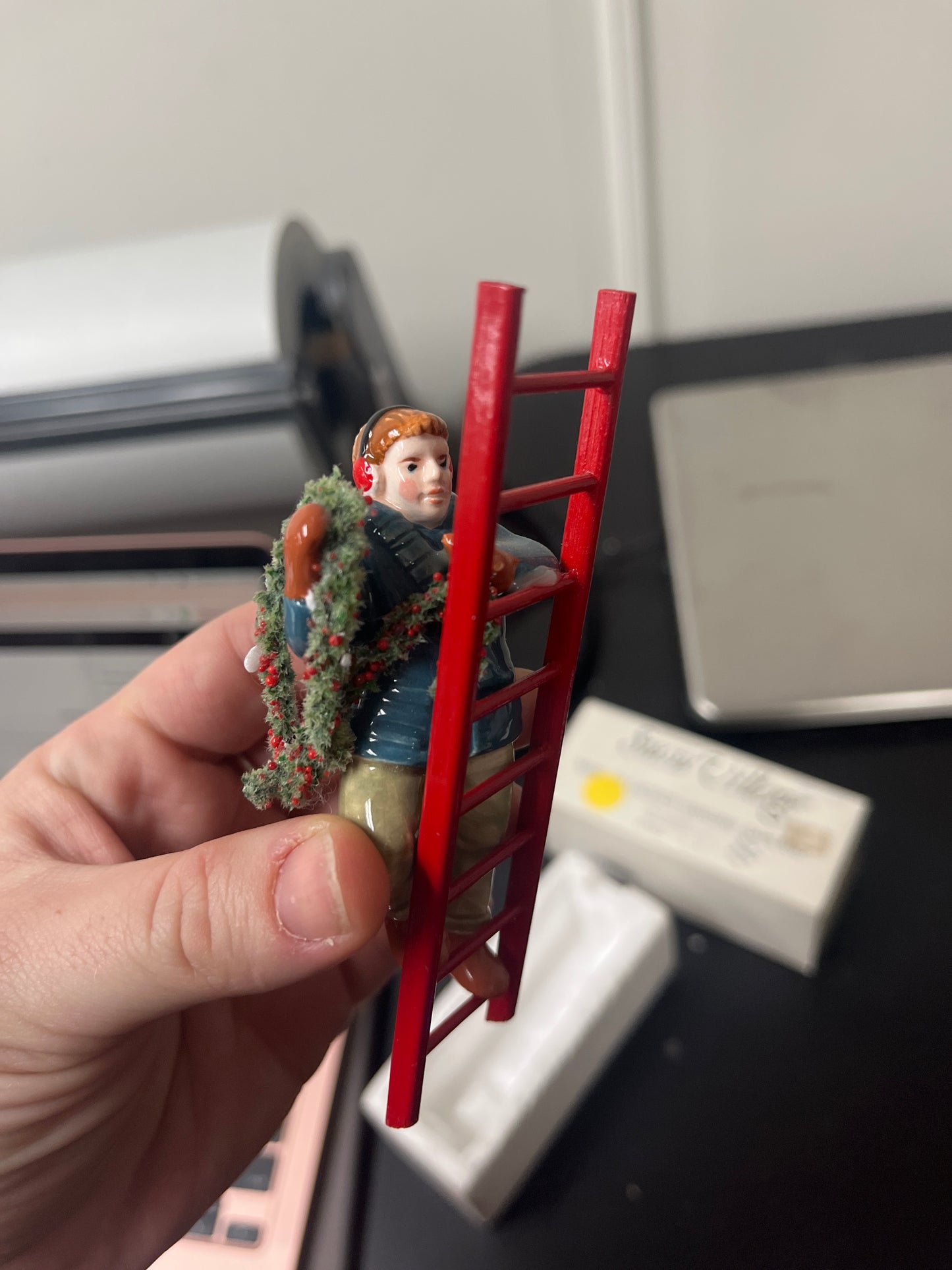 Man On Ladder Hanging Garland