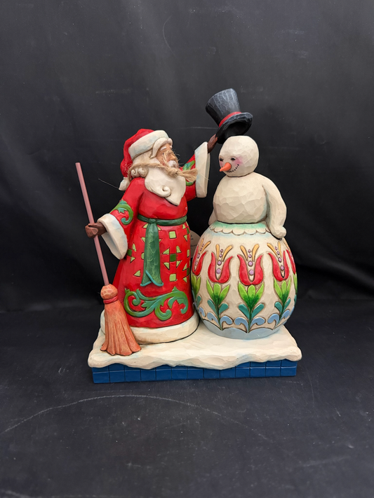 Share The Spirit. Santa Building Snowman